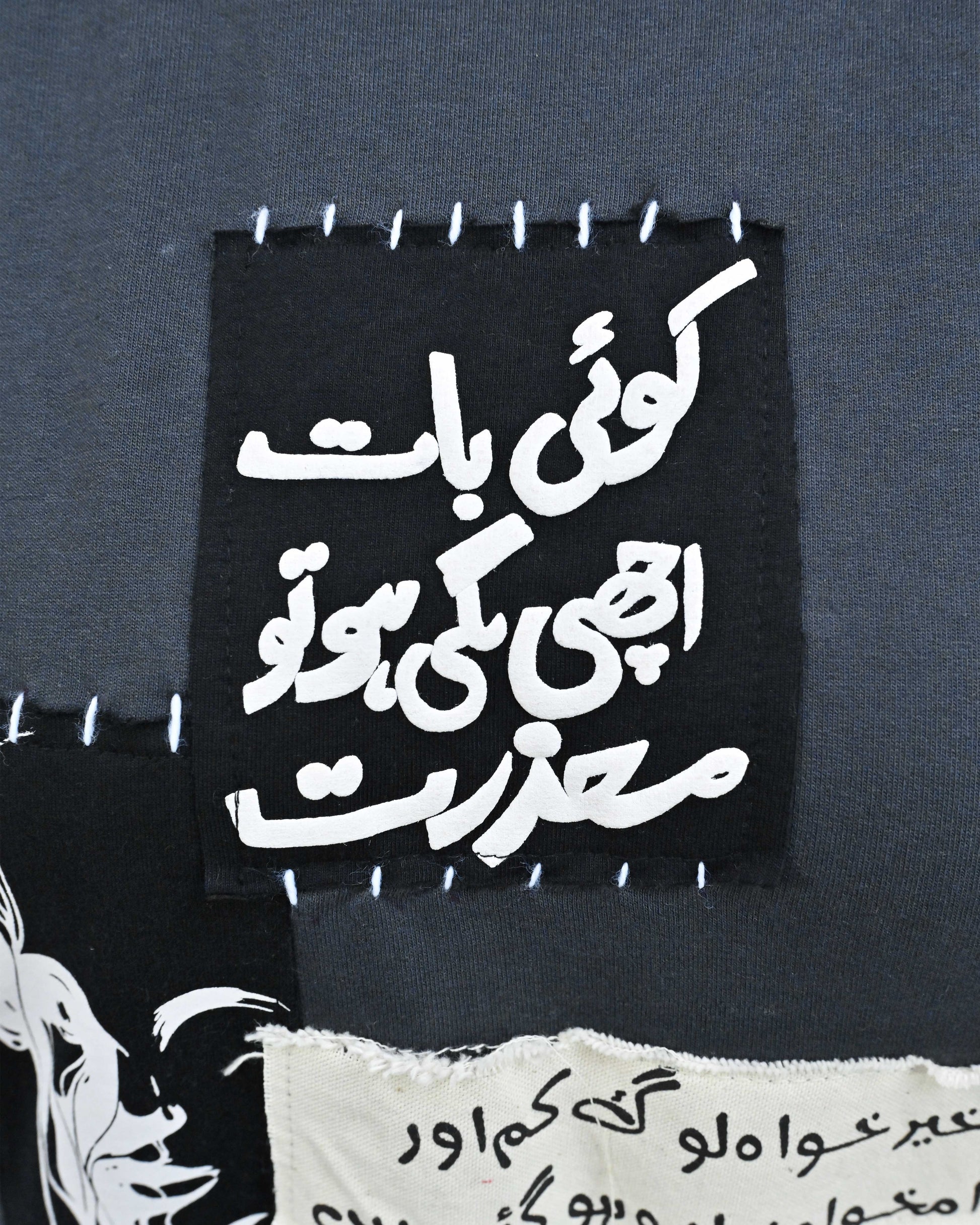 Person wearing "Chronicle" a white And Black graphic t-shirt with text on the back, standing against a white background made in pakistan