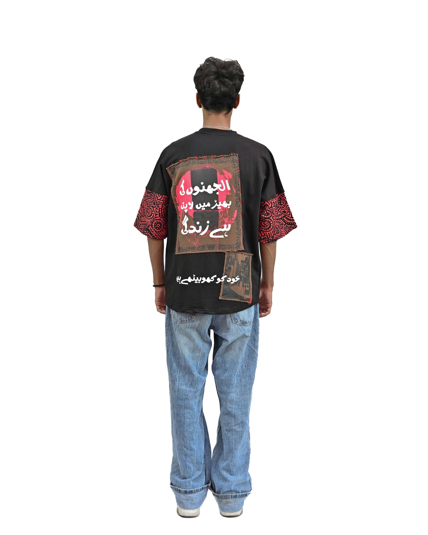 Person wearing "Lost in Grief" a Cream And Black graphic t-shirt with text on the back, standing against a white background made in pakistan