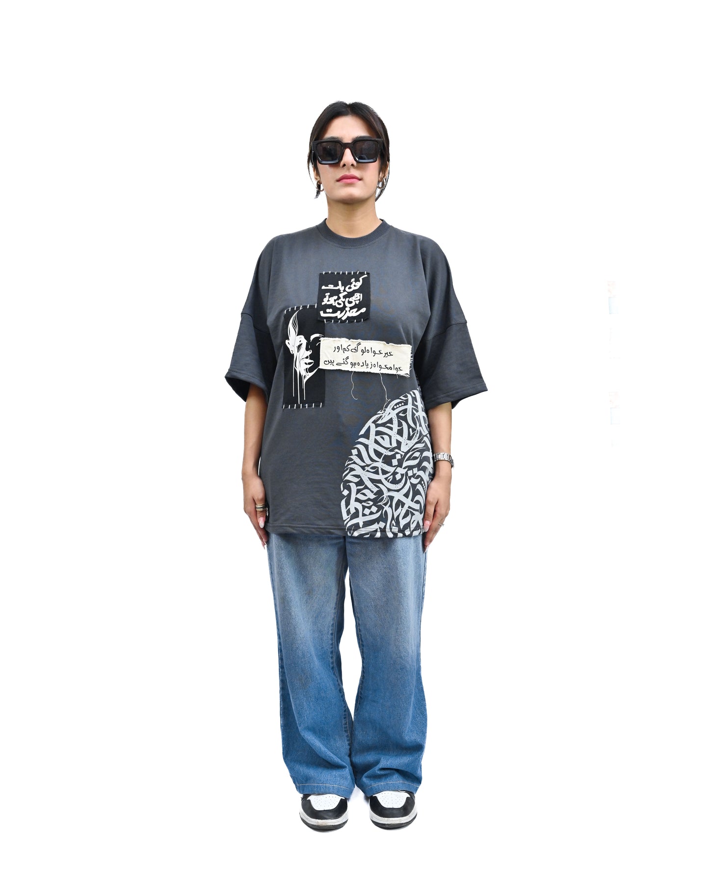 Person wearing "Chronicle" a white And Black graphic t-shirt with text on the back, standing against a white background made in pakistan