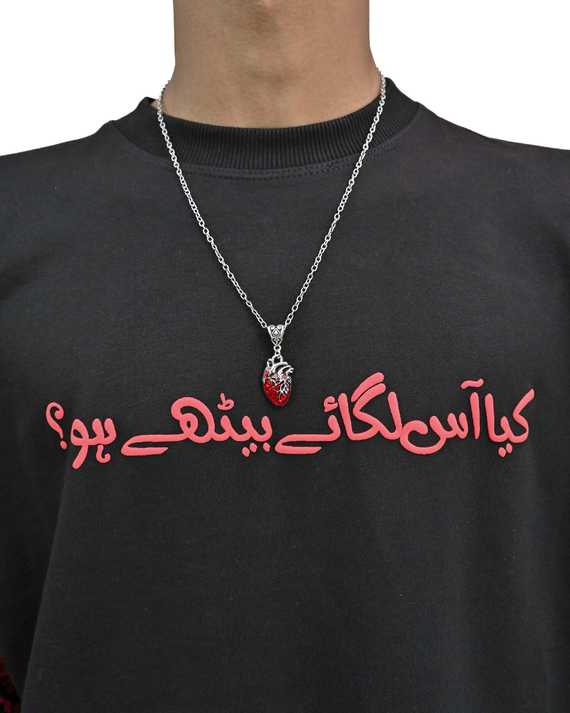 Person wearing "Lost in Grief" a Cream And Black graphic t-shirt with text on the back, standing against a white background made in pakistan