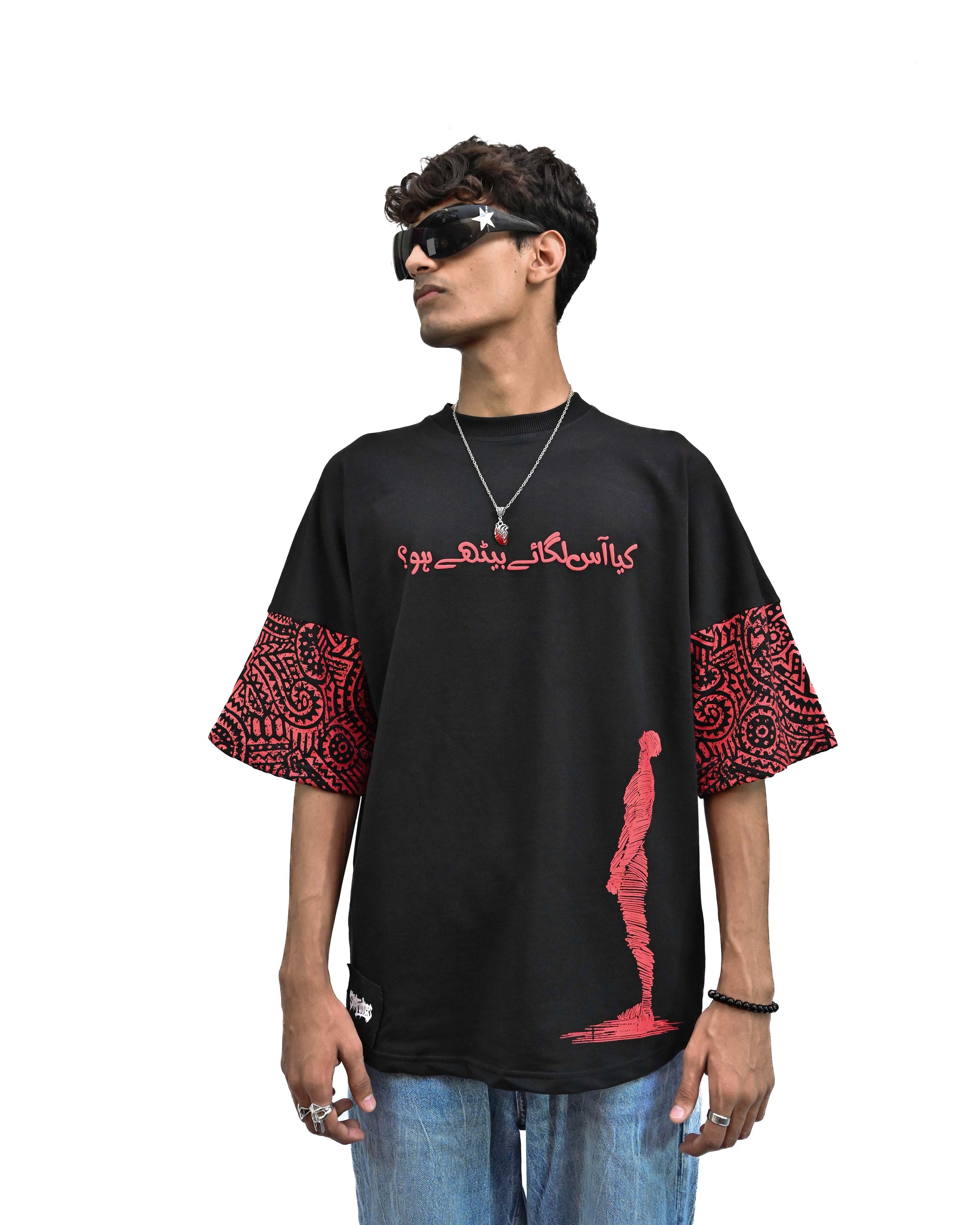 Person wearing "Lost in Grief" a Cream And Black graphic t-shirt with text on the back, standing against a white background made in pakistan