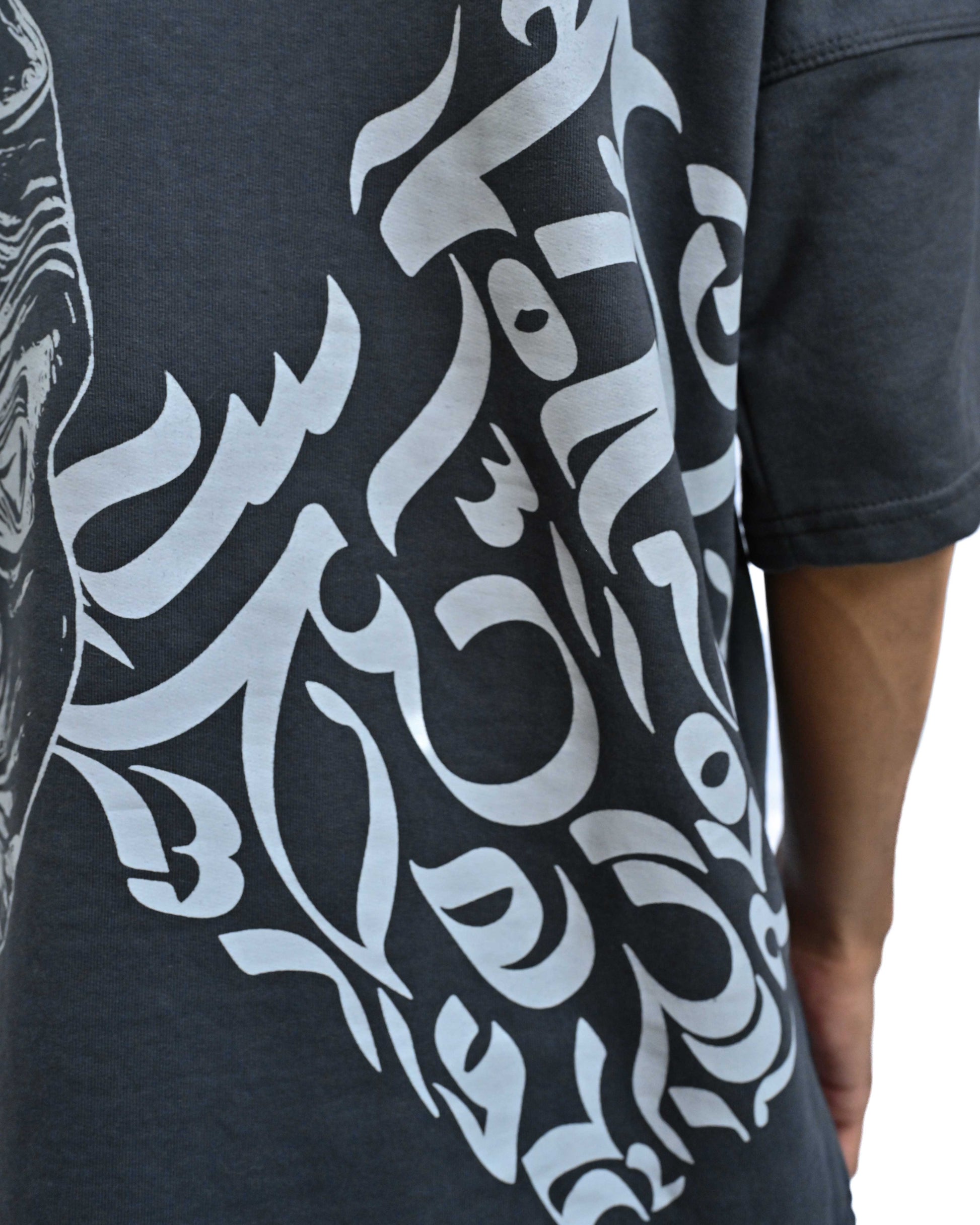 Person wearing "Chronicle" a white And Black graphic t-shirt with text on the back, standing against a white background made in pakistan