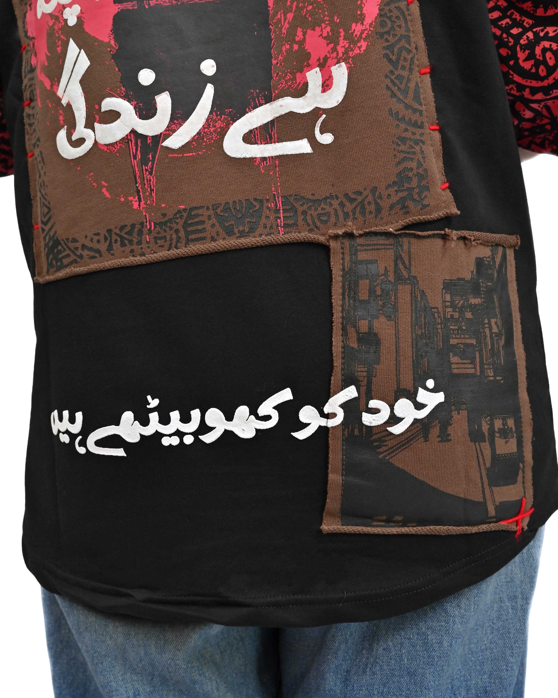 Person wearing "Lost in Grief" a Cream And Black graphic t-shirt with text on the back, standing against a white background made in pakistan