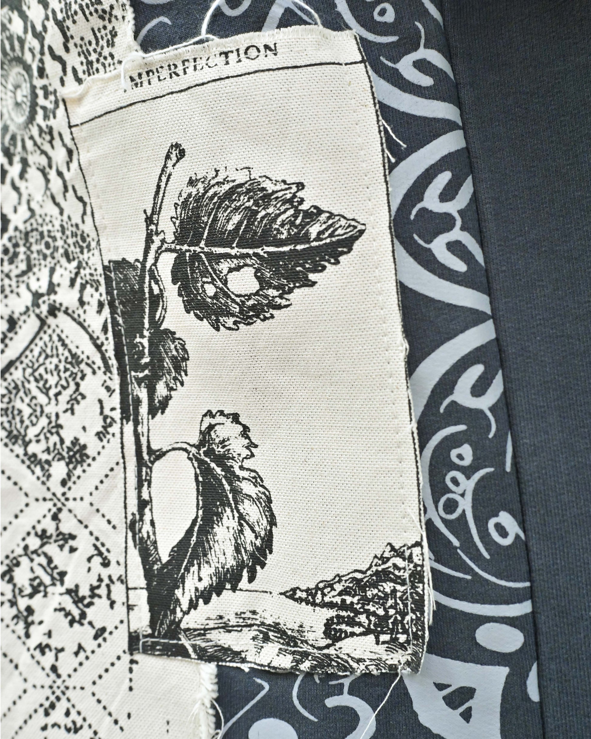 Person wearing "Ash Fade" a white graphic t-shirt with text on the back, standing against a white background made in pakistan