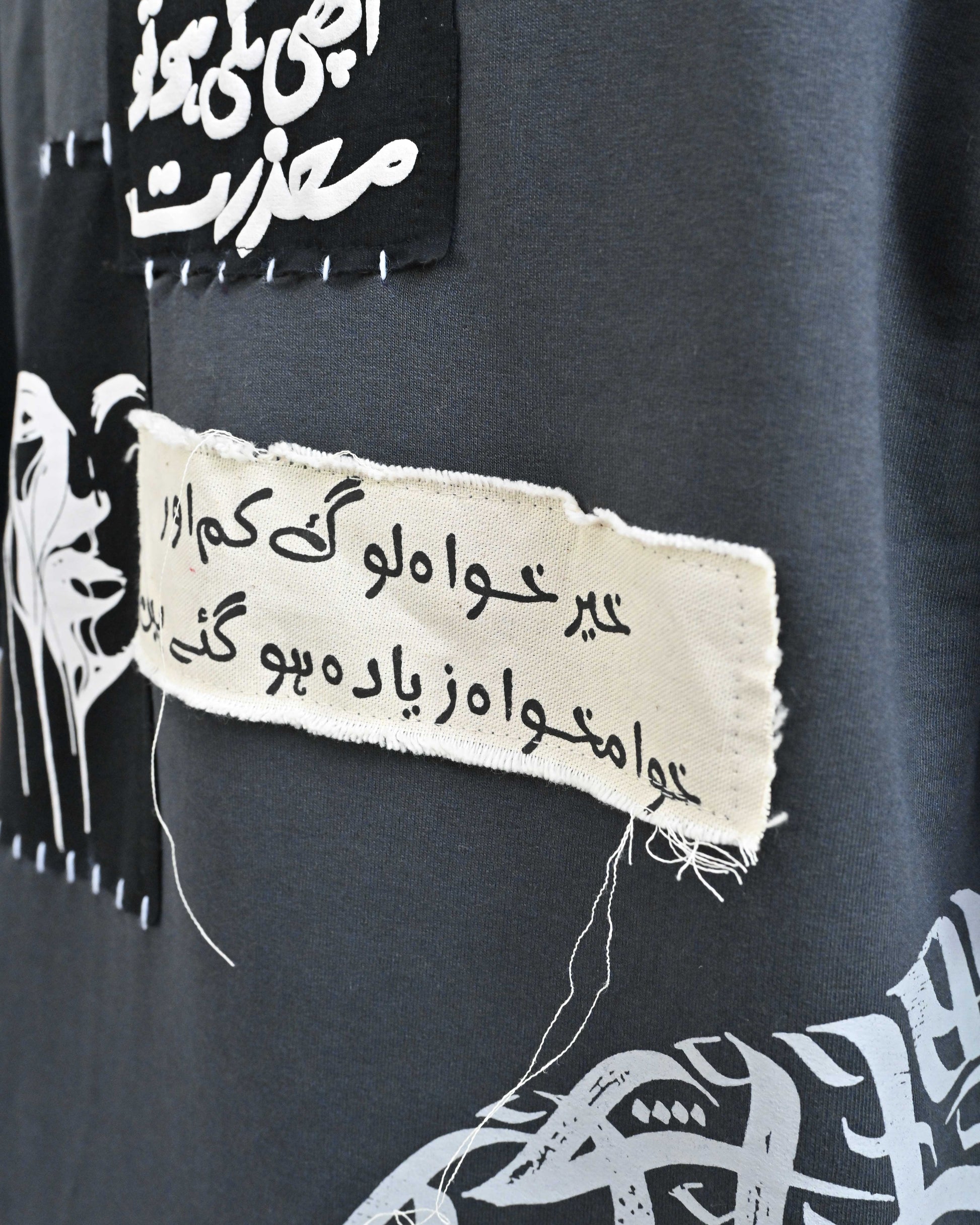 Person wearing "Chronicle" a white And Black graphic t-shirt with text on the back, standing against a white background made in pakistan