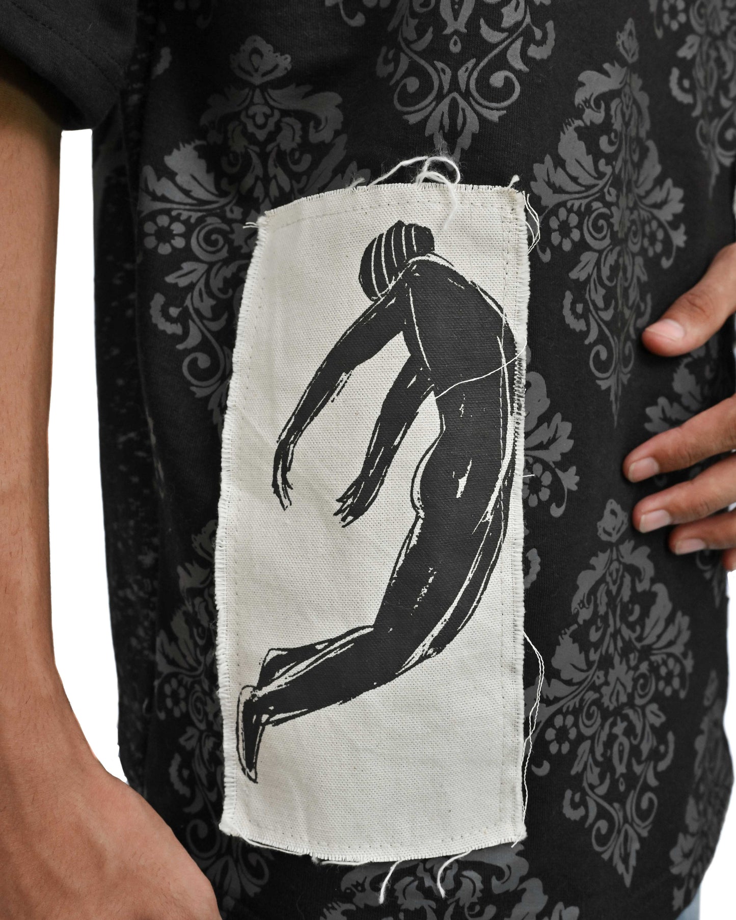 Person wearing "Black Verse" a white And Black graphic t-shirt with text on the back, standing against a white background made in pakistan