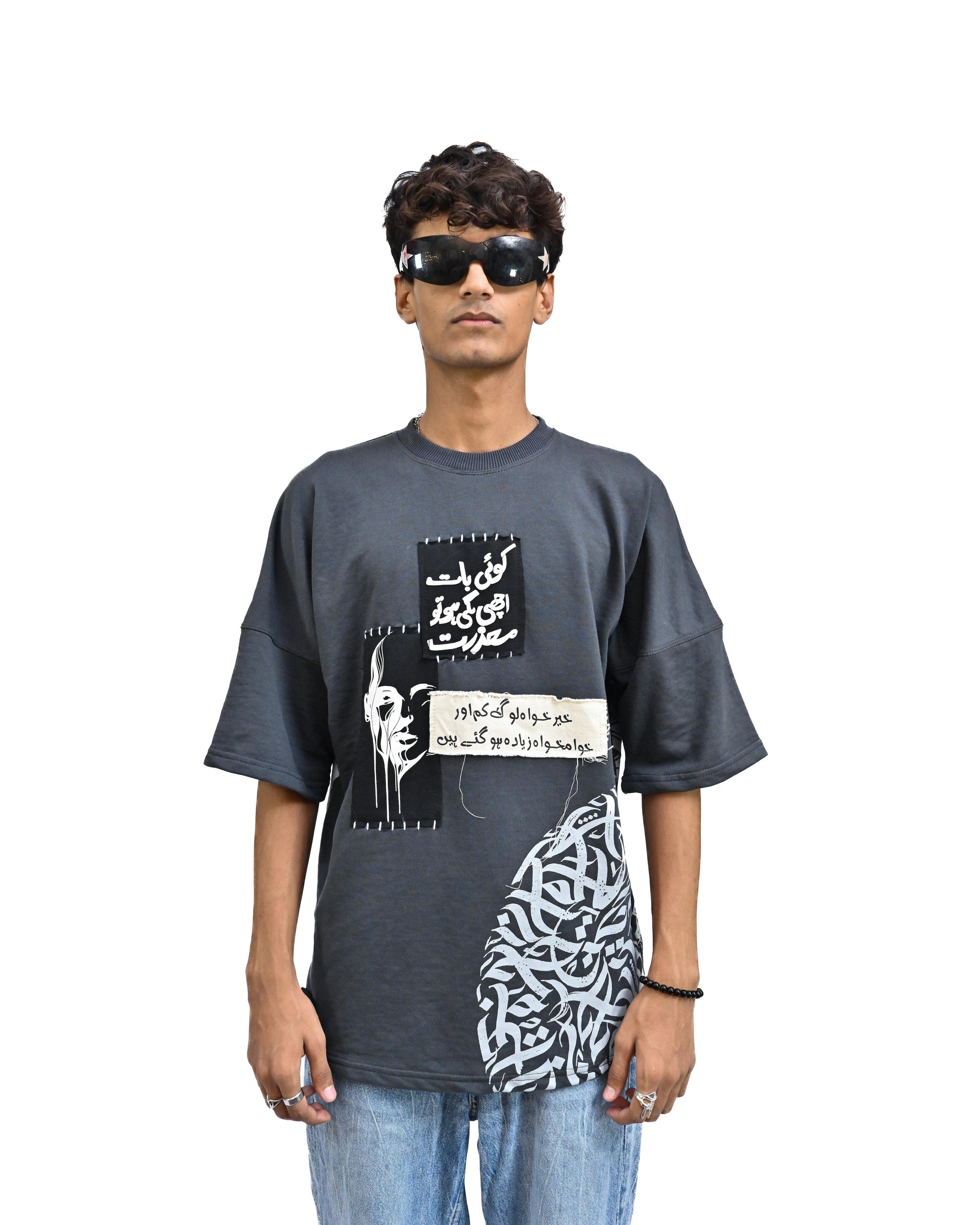 Person wearing "Chronicle" a white And Black graphic t-shirt with text on the back, standing against a white background made in pakistan