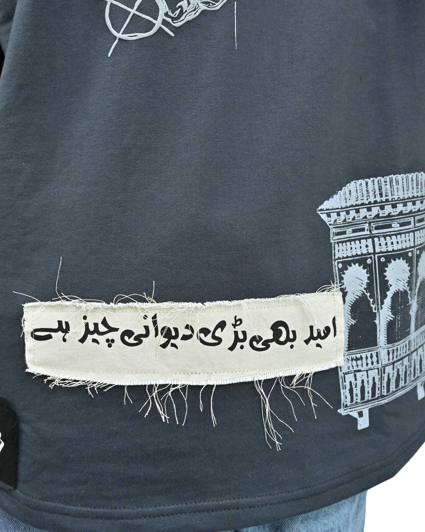 Person wearing "Ash Fade" a white graphic t-shirt with text on the back, standing against a white background made in pakistan