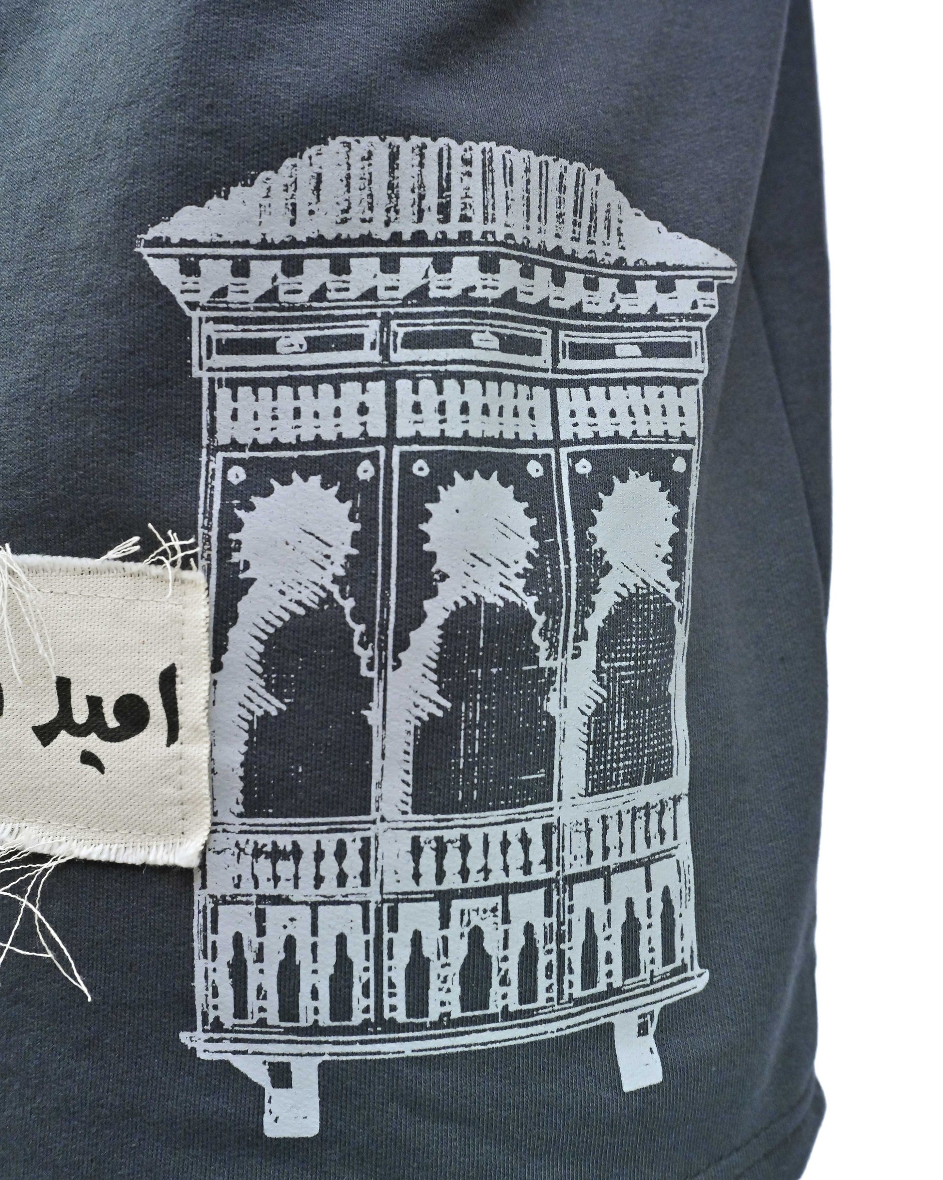 Person wearing "Ash Fade" a white graphic t-shirt with text on the back, standing against a white background made in pakistan