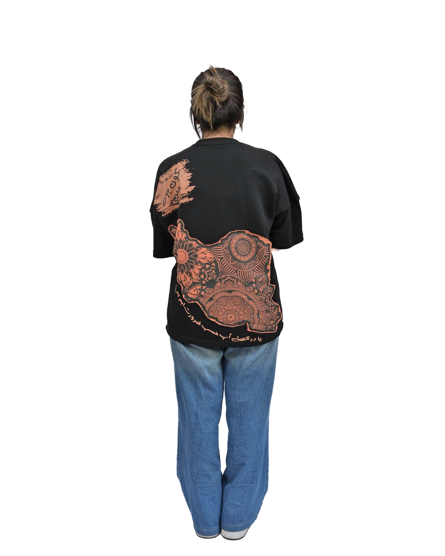Person wearing "Vese in Stone" a Cream And Black graphic t-shirt with text on the back, standing against a white background made in pakistan