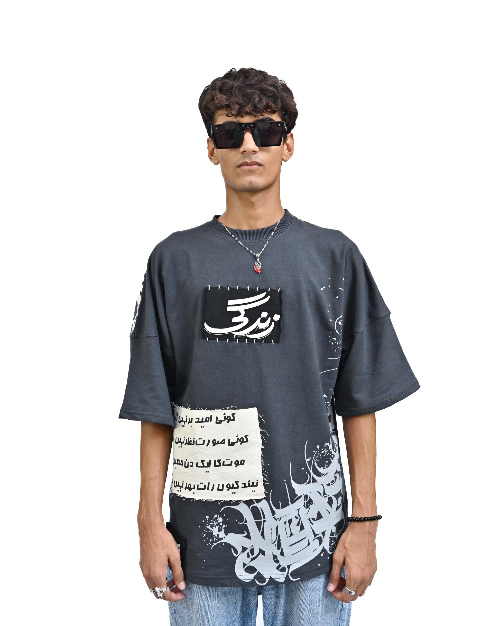 Person wearing "Stone & Spirit" a black and white graphic t-shirt with text on the back, standing against a white background.