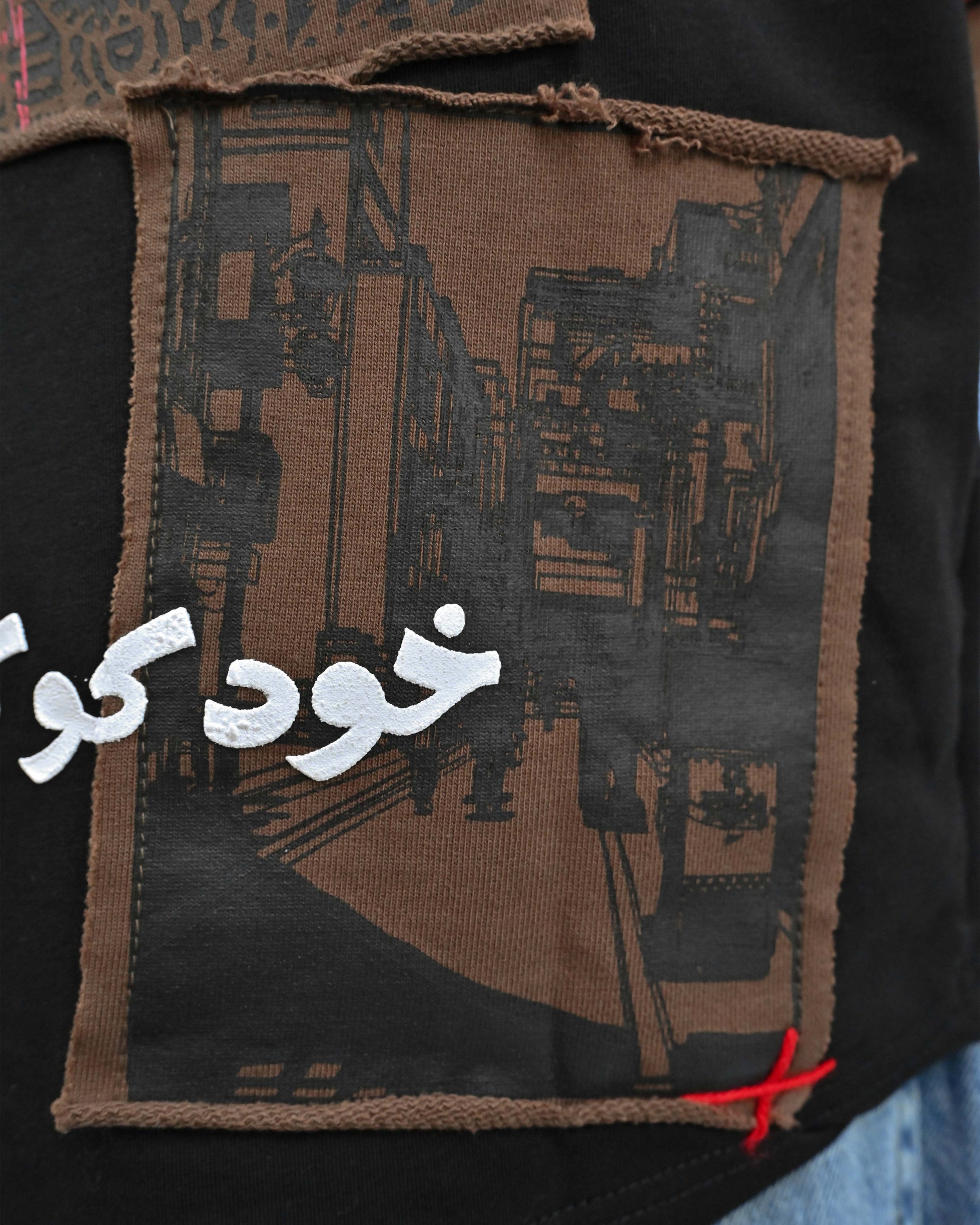 Person wearing "Lost in Grief" a Cream And Black graphic t-shirt with text on the back, standing against a white background made in pakistan