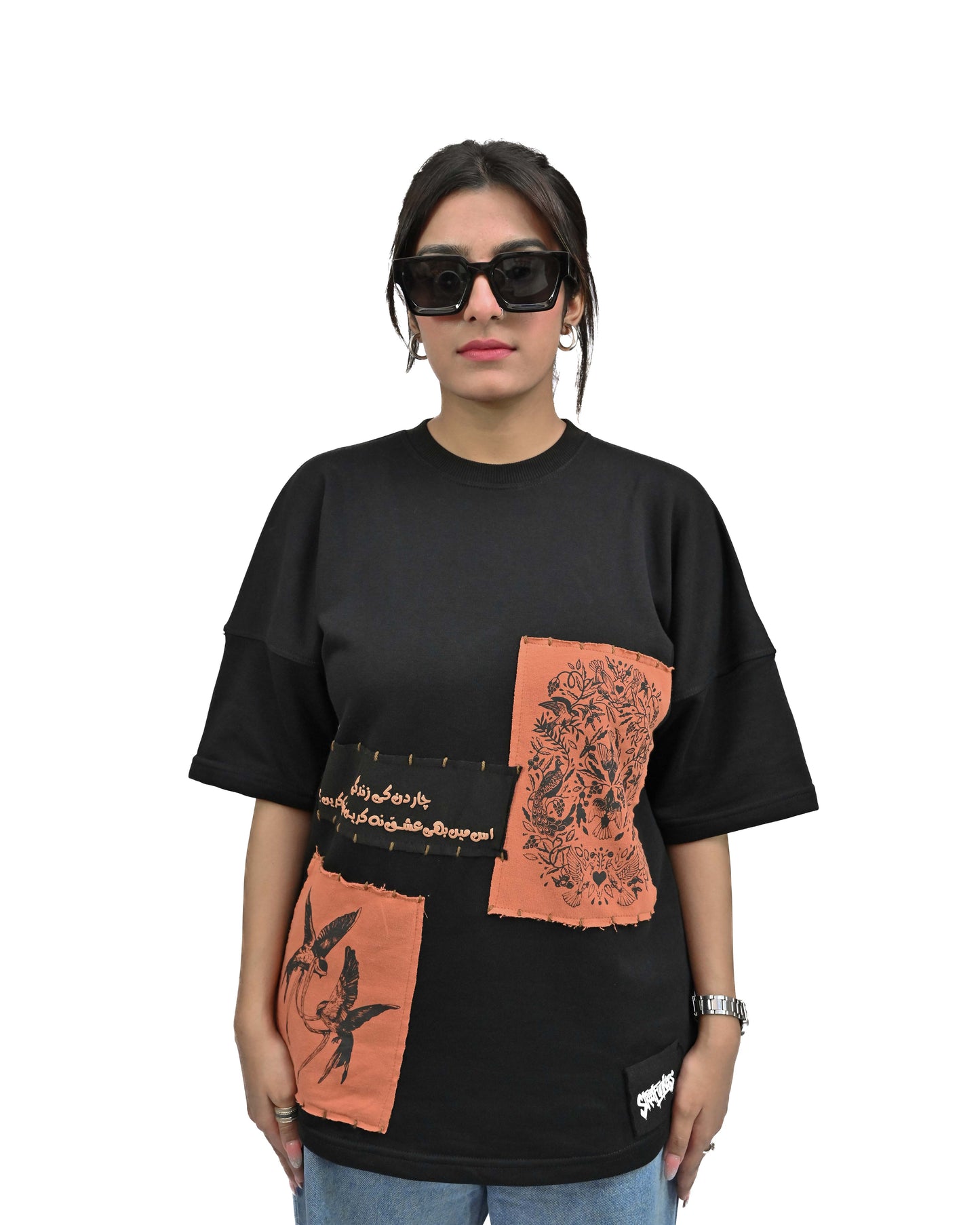 Person wearing "Vese in Stone" a Cream And Black graphic t-shirt with text on the back, standing against a white background made in pakistan