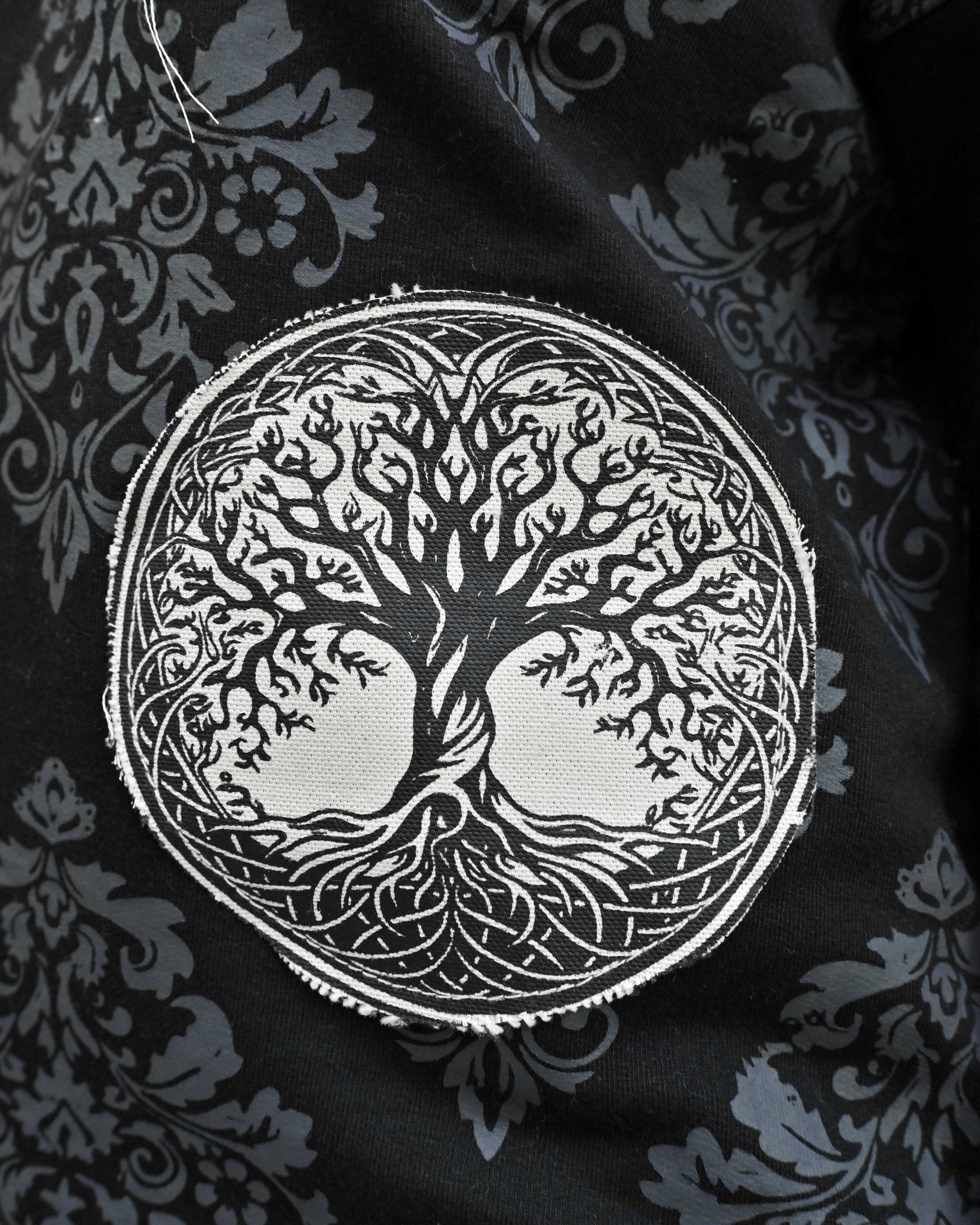 Person wearing "Black Verse" a white And Black graphic t-shirt with text on the back, standing against a white background made in pakistan