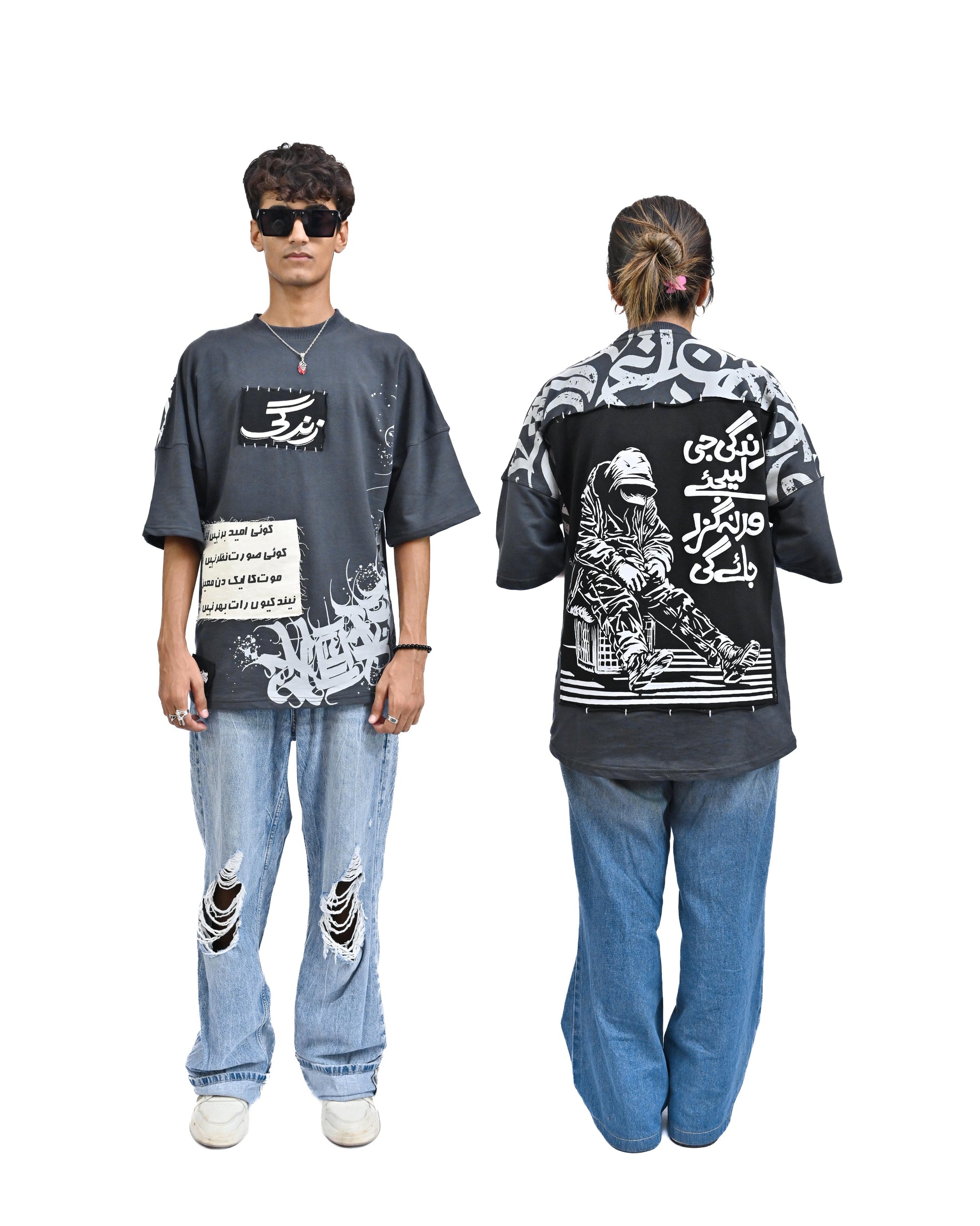 Person wearing "Stone & Spirit" a black and white graphic t-shirt with text on the back, standing against a white background.