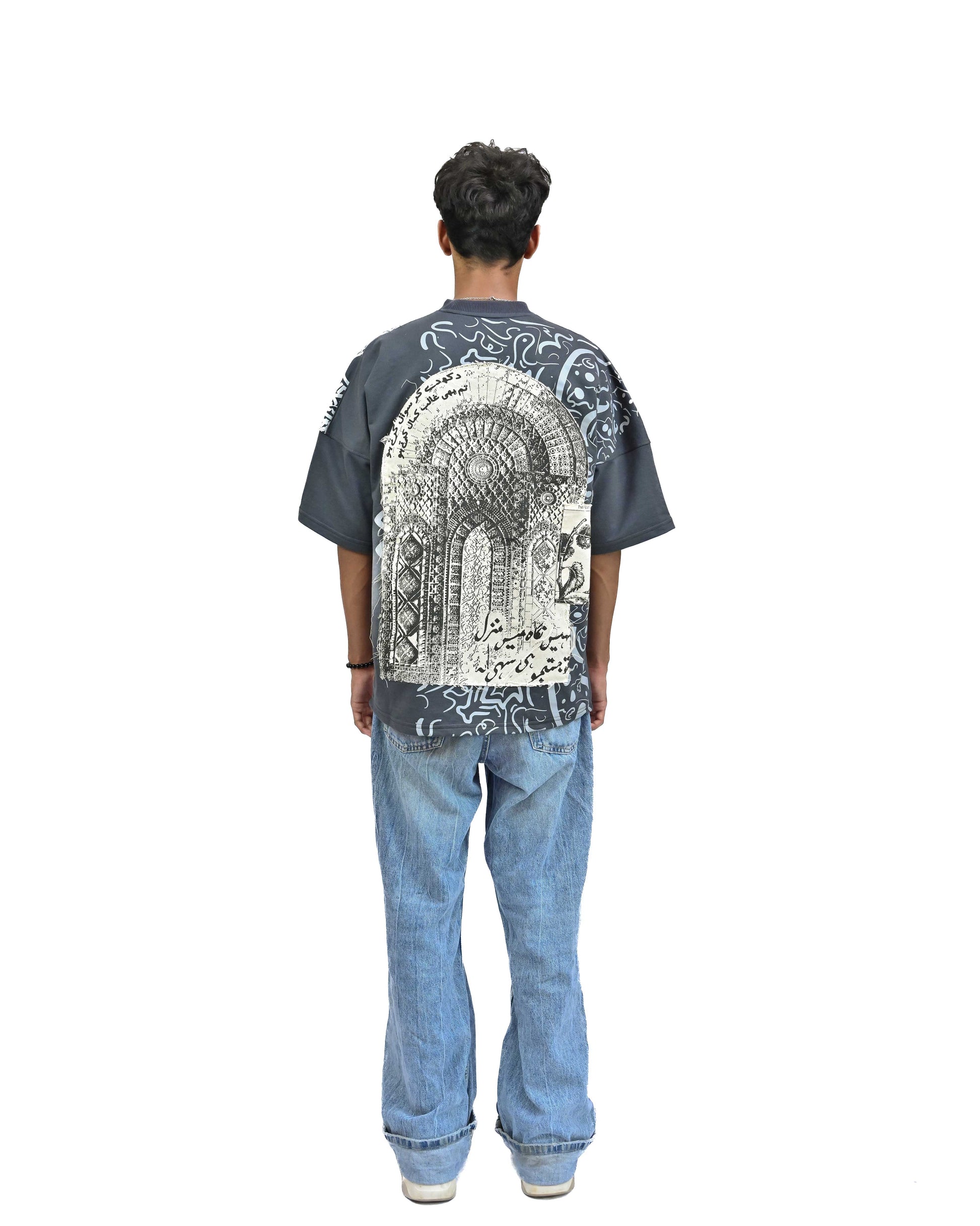 Person wearing "Ash Fade" a white graphic t-shirt with text on the back, standing against a white background made in pakistan