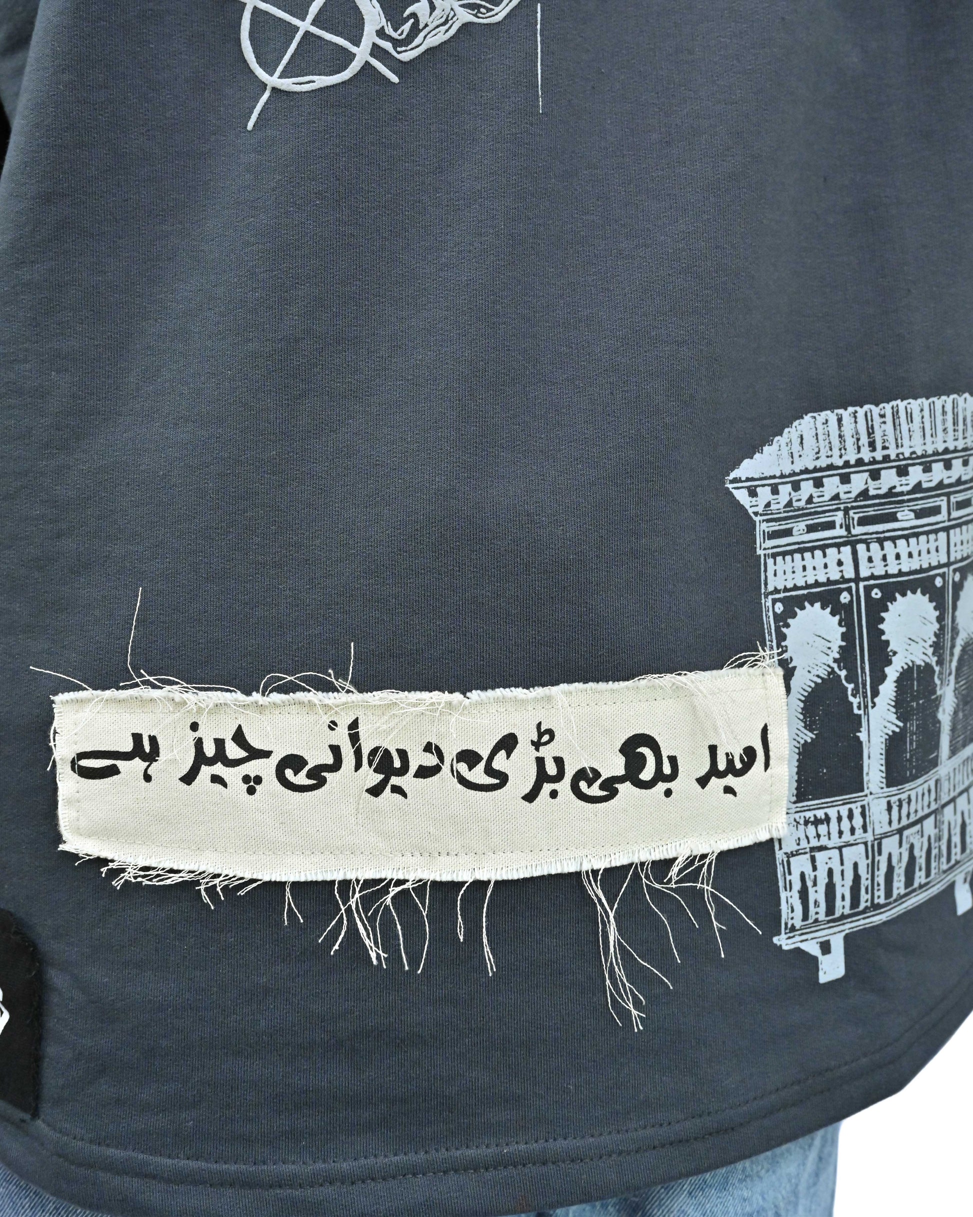 Person wearing "Ash Fade" a white graphic t-shirt with text on the back, standing against a white background made in pakistan