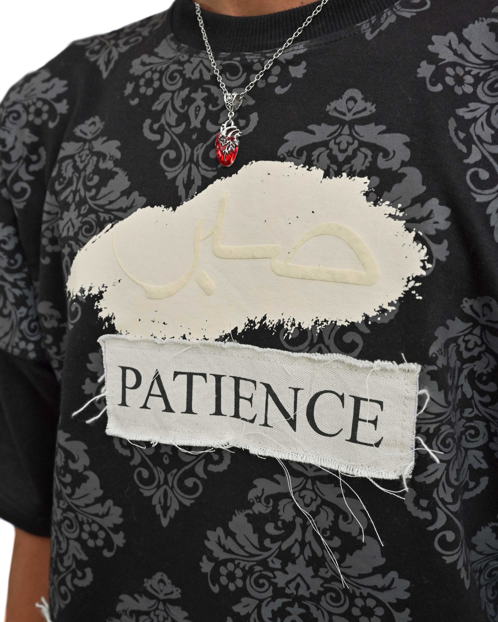 Person wearing "Black Verse" a white And Black graphic t-shirt with text on the back, standing against a white background made in pakistan