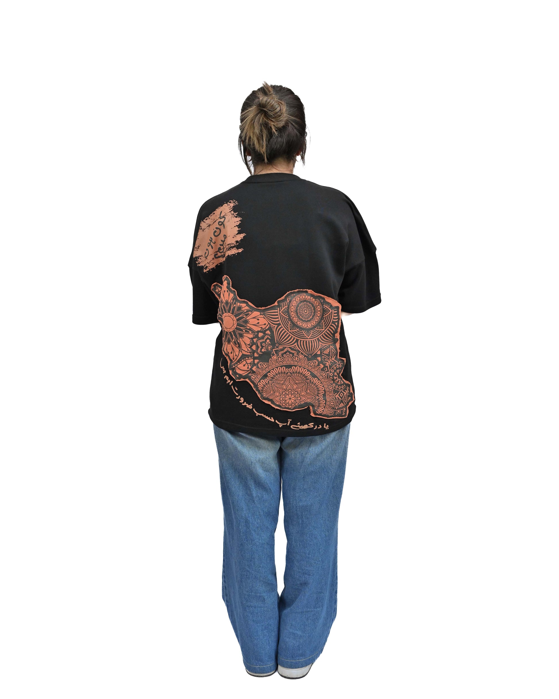 Person wearing "Vese in Stone" a Cream And Black graphic t-shirt with text on the back, standing against a white background made in pakistan